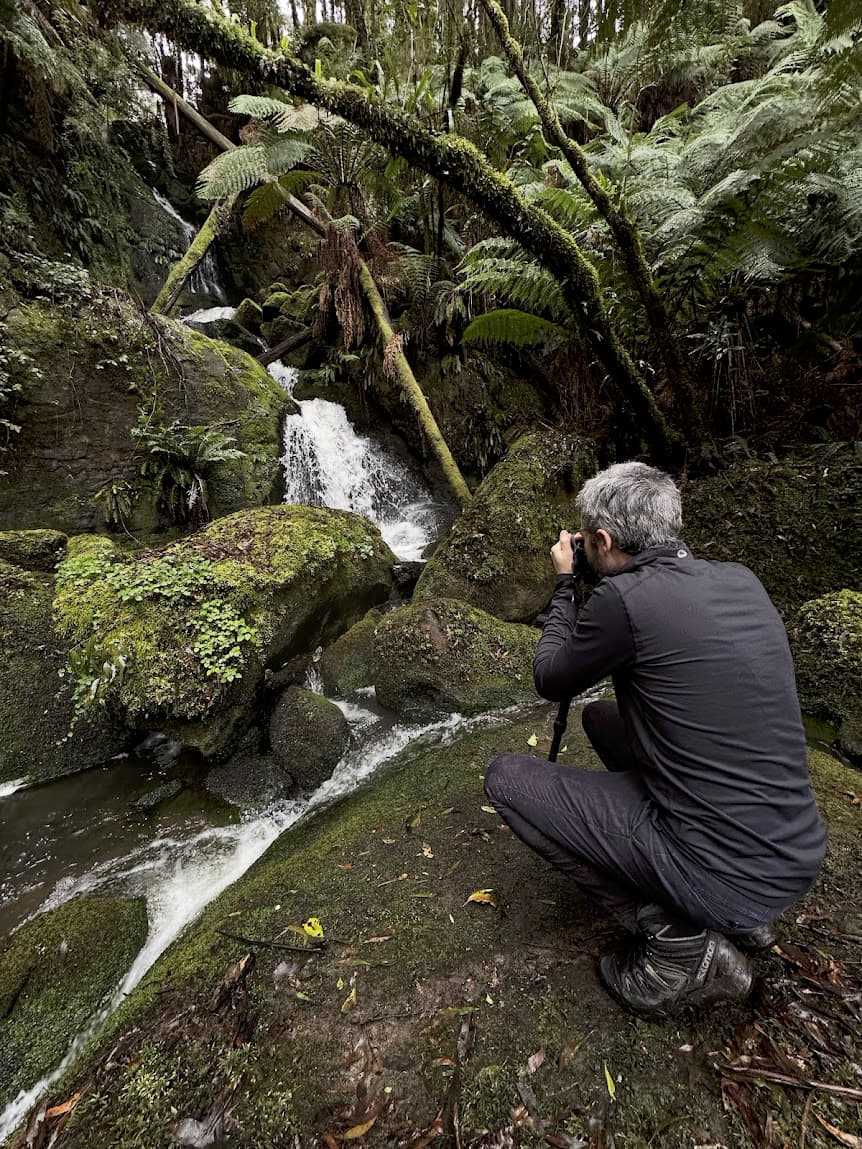 Alex photographing a waterfall in the forest